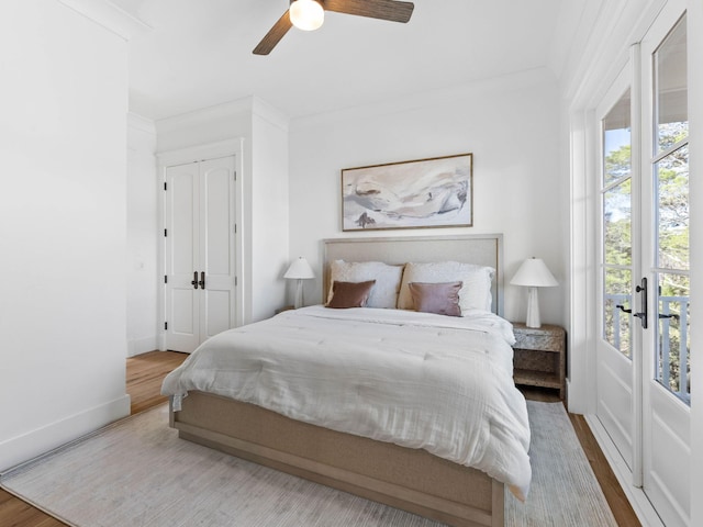 bedroom featuring ceiling fan, hardwood / wood-style flooring, and ornamental molding