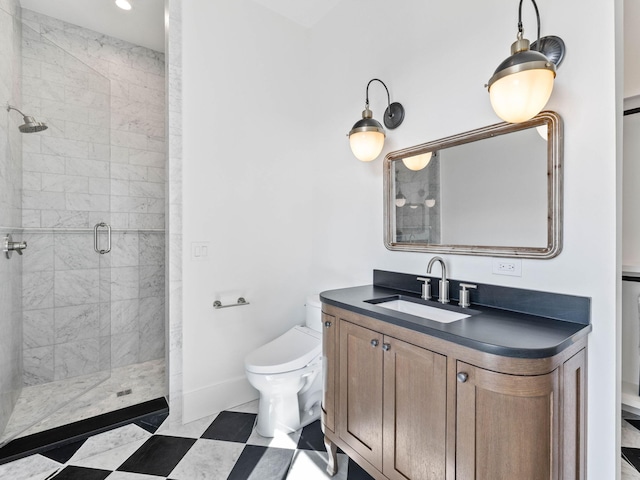 bathroom featuring a shower with shower door, vanity, and toilet