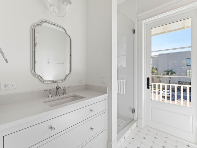 bathroom featuring walk in shower and vanity