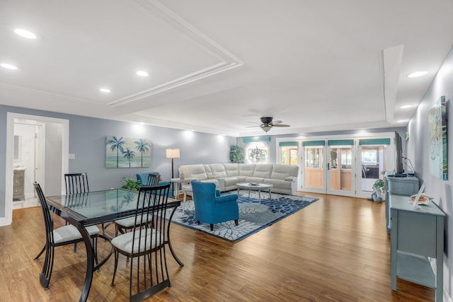 living room featuring french doors, hardwood / wood-style flooring, ceiling fan, and a tray ceiling