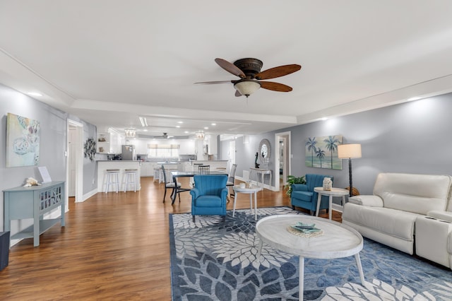 living room with ceiling fan and wood-type flooring