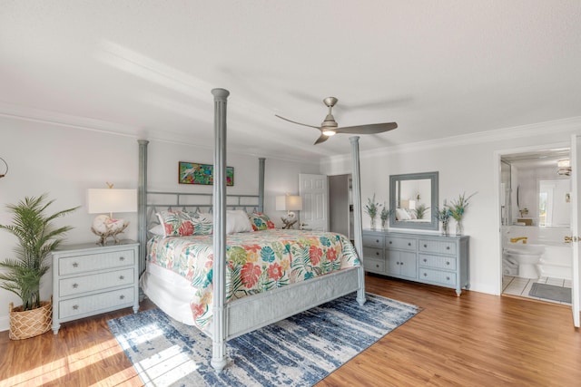 bedroom featuring ceiling fan, wood-type flooring, ensuite bathroom, and ornamental molding