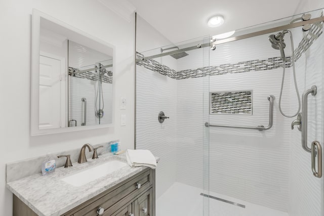 bathroom featuring vanity and an enclosed shower