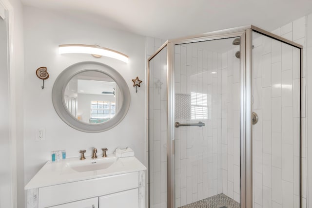 bathroom featuring vanity and a shower with shower door