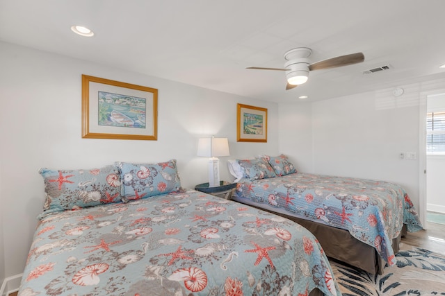 bedroom with ceiling fan and wood-type flooring