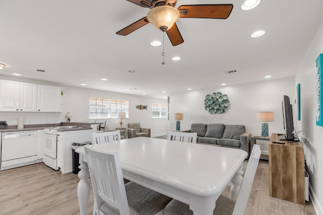 dining space with ceiling fan and light hardwood / wood-style floors