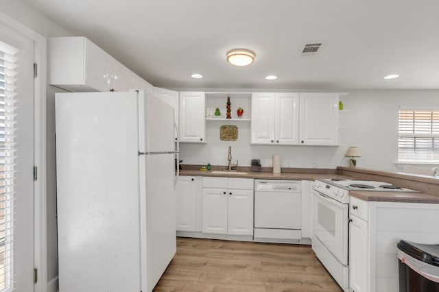 kitchen with light wood-type flooring, white appliances, white cabinets, and sink