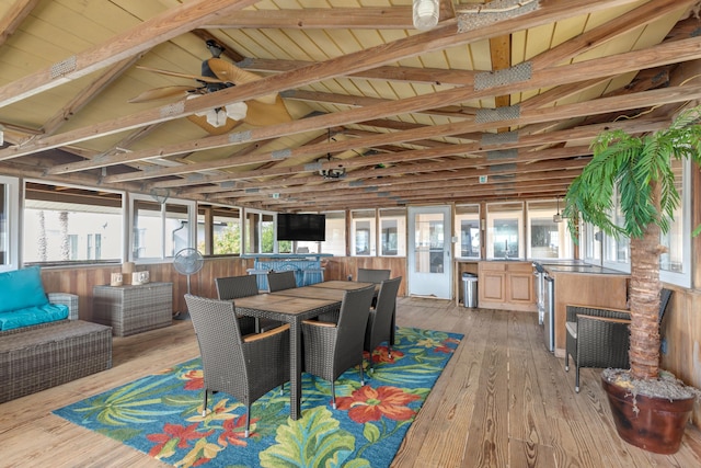 sunroom with vaulted ceiling with beams, ceiling fan, and wood ceiling