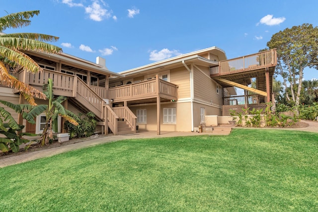 rear view of property with a patio and a lawn