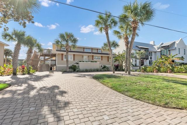 view of front facade featuring a front yard and a wooden deck