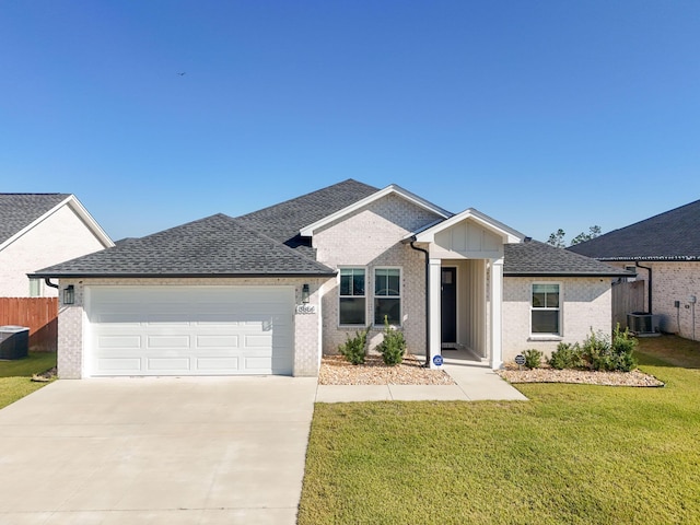 single story home with central AC unit, a garage, and a front lawn