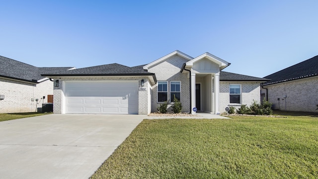 view of front of property with a garage, a front yard, and central AC