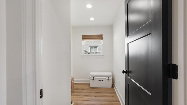 hallway with light hardwood / wood-style floors