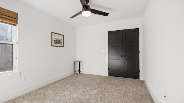 empty room with ceiling fan and carpet floors