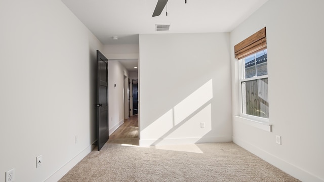 carpeted empty room with ceiling fan