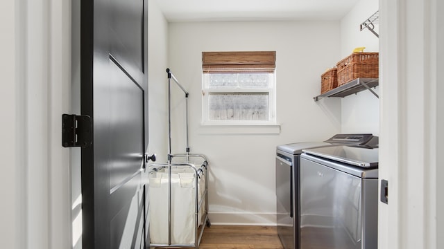 laundry area featuring separate washer and dryer and hardwood / wood-style floors