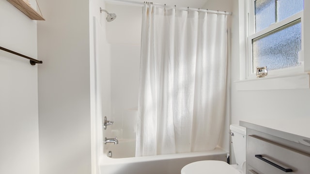 bathroom featuring toilet and shower / bath combo with shower curtain