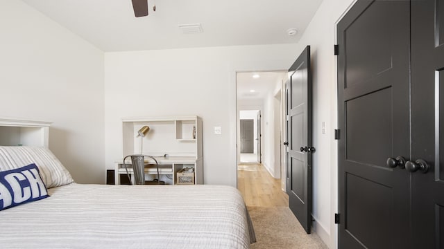 bedroom with ceiling fan and light carpet