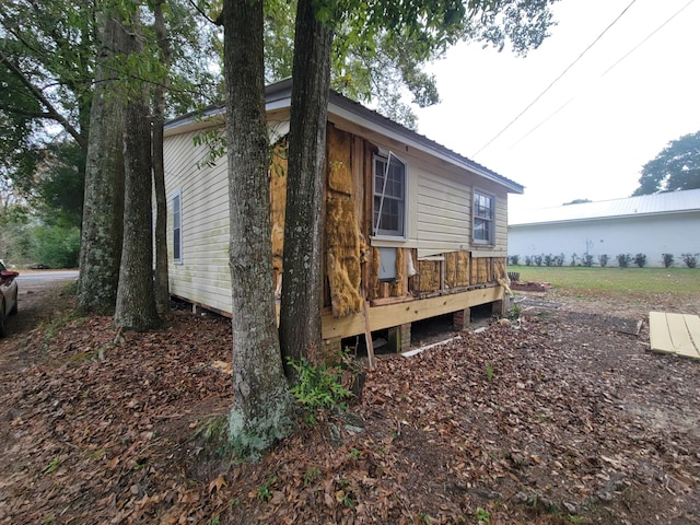 view of property exterior with a deck