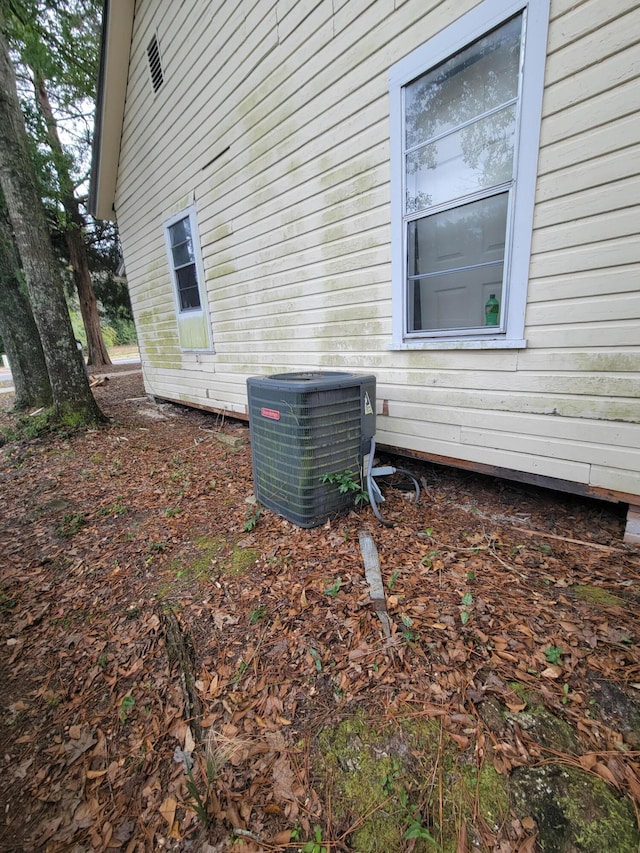 view of side of home with central air condition unit