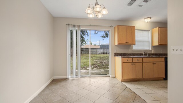 kitchen featuring decorative light fixtures, light tile patterned flooring, sink, and an inviting chandelier