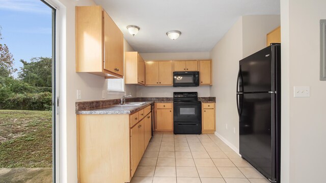 kitchen featuring light brown cabinets, sink, light tile patterned floors, and black appliances