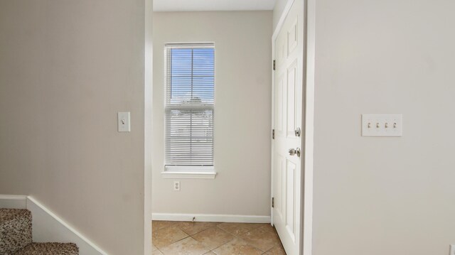 doorway featuring light tile patterned flooring