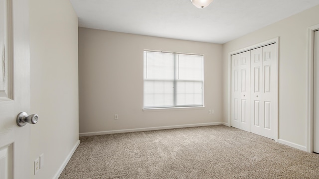 unfurnished bedroom featuring a closet and carpet floors