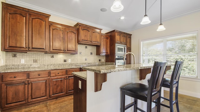 kitchen with appliances with stainless steel finishes, backsplash, crown molding, hanging light fixtures, and an island with sink