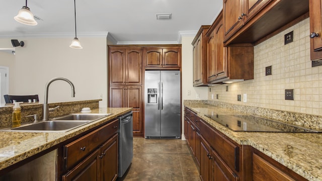 kitchen featuring light stone countertops, sink, hanging light fixtures, stainless steel appliances, and crown molding