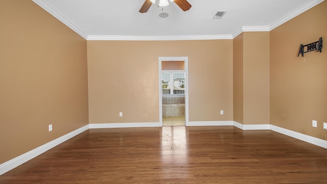 empty room featuring ceiling fan, hardwood / wood-style floors, and ornamental molding