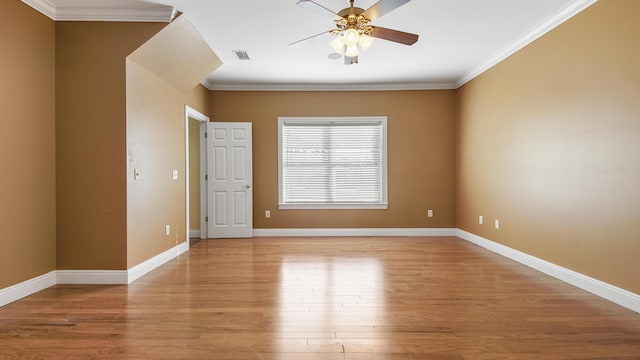 empty room featuring ceiling fan, light hardwood / wood-style flooring, and ornamental molding