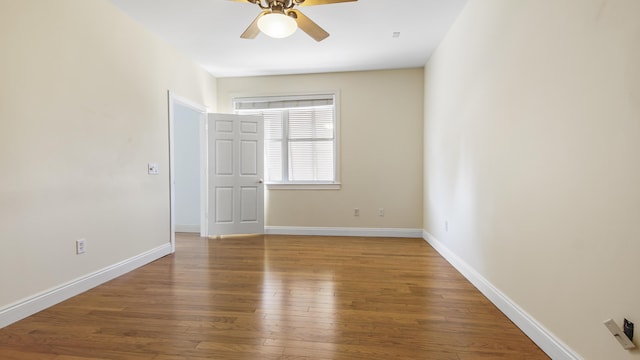 spare room with wood-type flooring and ceiling fan