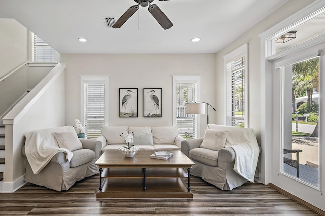 living room featuring dark hardwood / wood-style floors and ceiling fan