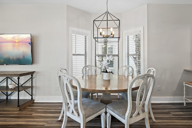 dining room featuring a healthy amount of sunlight, a chandelier, and dark hardwood / wood-style flooring