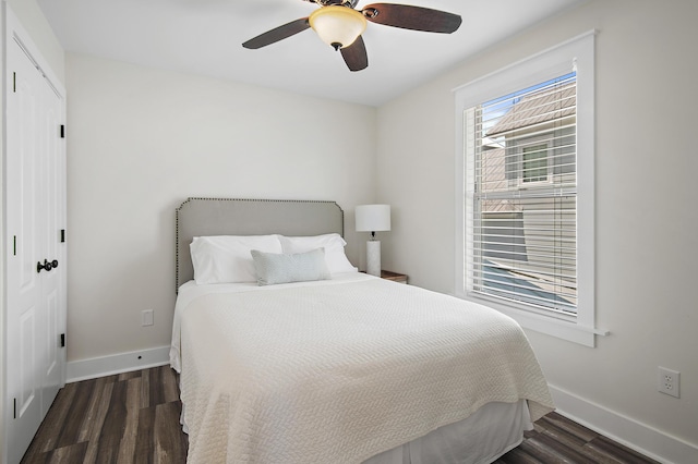 bedroom with dark hardwood / wood-style flooring, a closet, and ceiling fan