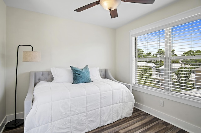 bedroom with dark wood-type flooring and ceiling fan