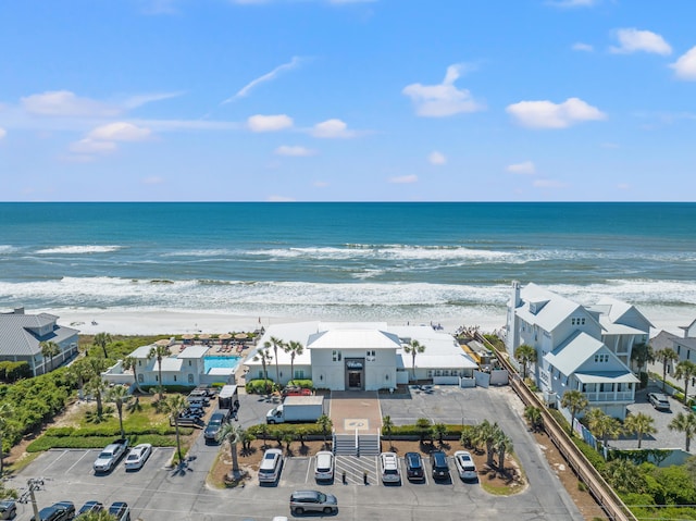 birds eye view of property with a water view and a beach view