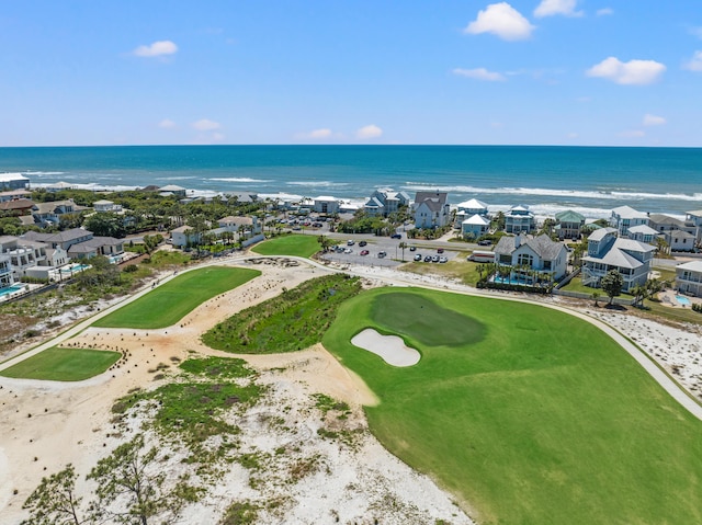 birds eye view of property with a water view and a beach view