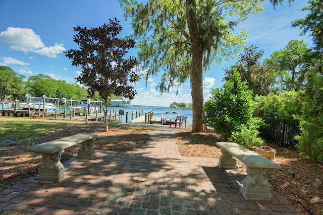 view of property's community featuring a water view and a dock