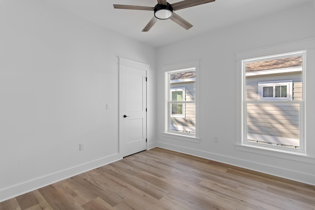 unfurnished room with ceiling fan and light wood-type flooring