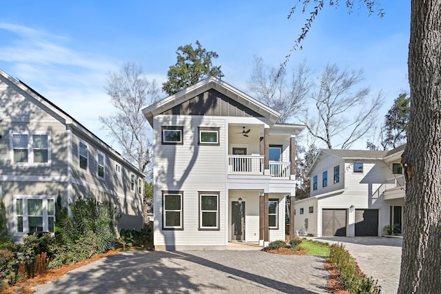 view of front of property featuring a balcony and ceiling fan