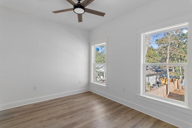 empty room featuring ceiling fan and light hardwood / wood-style flooring