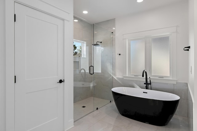 bathroom with shower with separate bathtub