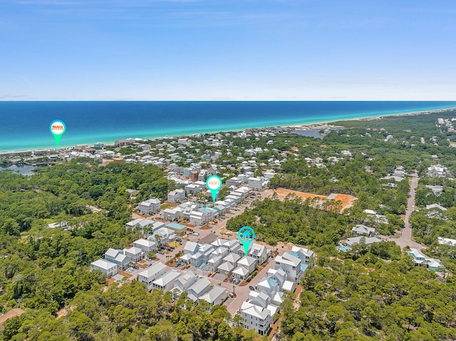 birds eye view of property featuring a beach view and a water view