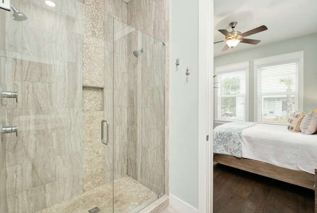 bathroom featuring hardwood / wood-style flooring, an enclosed shower, and ceiling fan