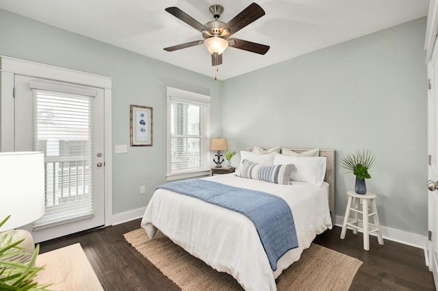 bedroom with access to exterior, ceiling fan, dark hardwood / wood-style flooring, and multiple windows