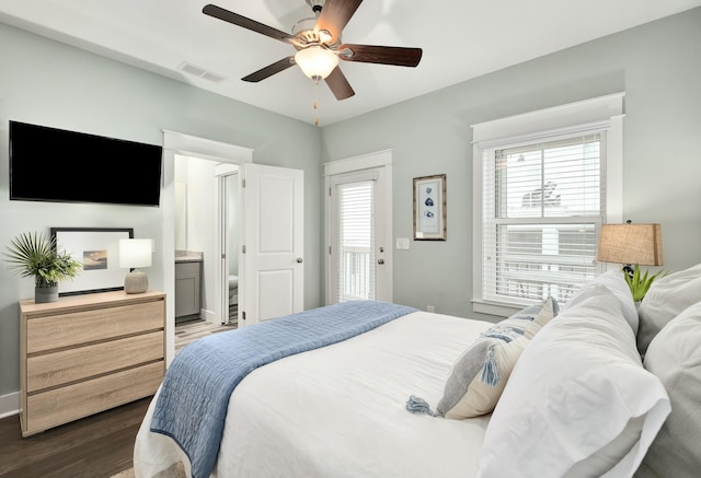 bedroom with connected bathroom, dark hardwood / wood-style floors, and ceiling fan