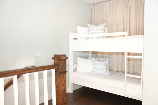 bedroom with dark hardwood / wood-style floors