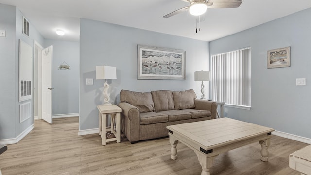 living room with light hardwood / wood-style floors and ceiling fan